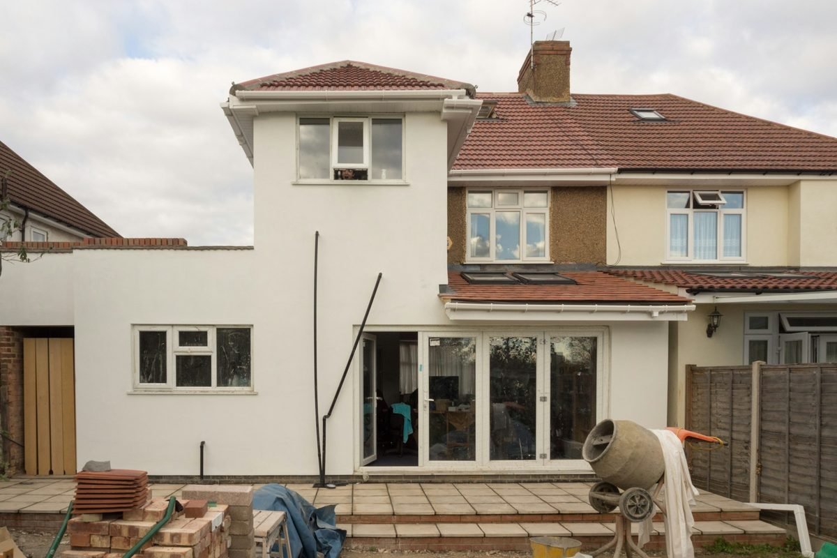 House mid-renovation with new windows framed in, showing the kind of repairs a cash buyer budgets for