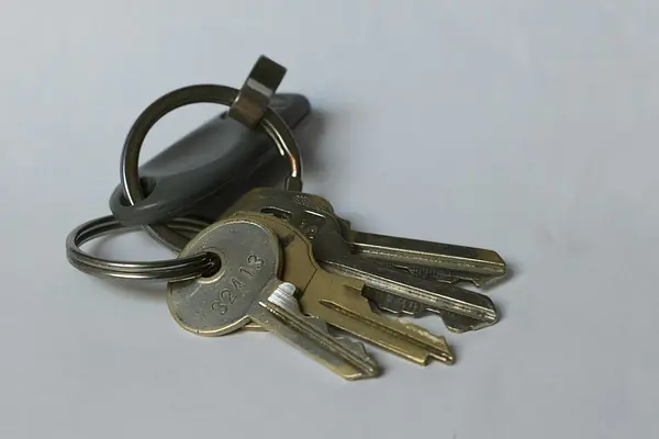 Set of house keys on a white table, ready to hand over at closing